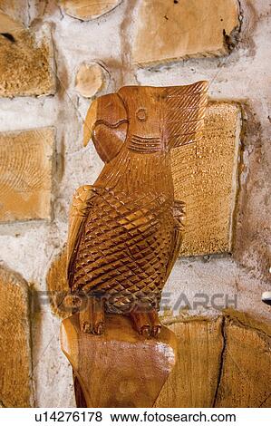 Stock Photo - wall, wooden, cabin, perched, parrot, carved. Fotosearch