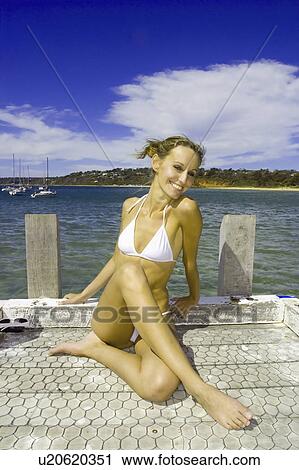 Stock Image - white, young, relaxing, female, woman, beautiful. Fotosearch