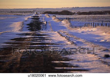 Stock Image - winter, grid, drifting, snow, road, gravel. Fotosearch