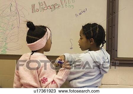 Stock Image - year, blackboard, girls, old, two. Fotosearch