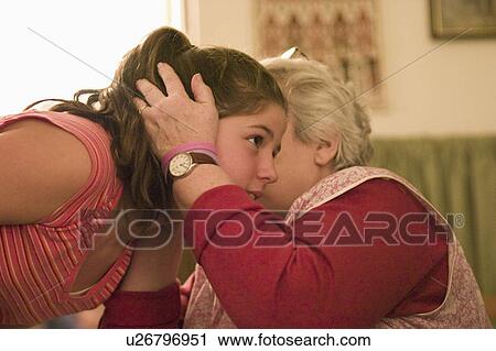 Stock Image - 12, whispering, 70, age, secret, grandma. Fotosearch