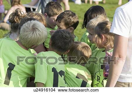 Picture - 28, coach, age, players, instructing, soccer. Fotosearch