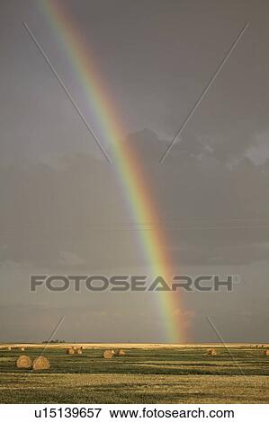 Stock Photo - background, bales, rainbow, clouds, storm, hay. Fotosearch