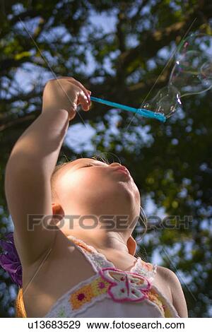 Stock Photo - blow, girl, halaya, bubbles, blowing, little. Fotosearch