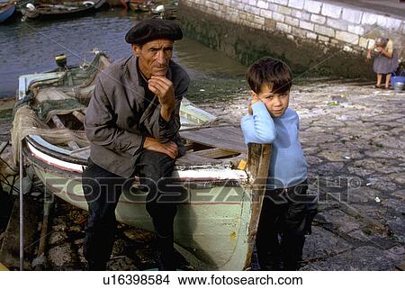 Picture - boat, fisherman, draped, fishnet, sits, portuguese. Fotosearch