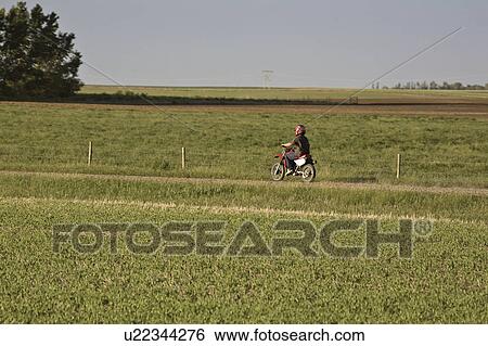 Stock Photograph - canada, dirt, saskatchewan, scenic, bike, youth. Fotosearch