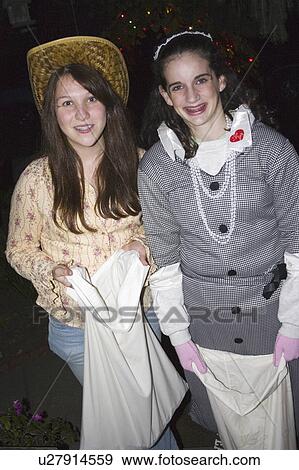 Stock Photo - candy, teenage, treaters, tricks, halloween, costumed. Fotosearch
