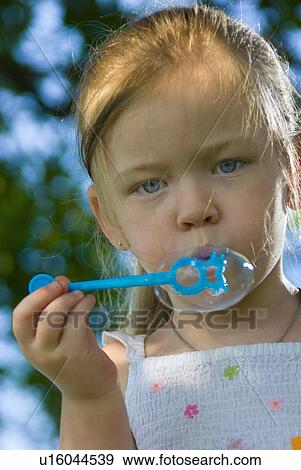 child, girl, blow, bubbles, blowing, little View Large Photo Image Stock Photo - child, girl, blow, bubbles, blowing, little. Fotosearch