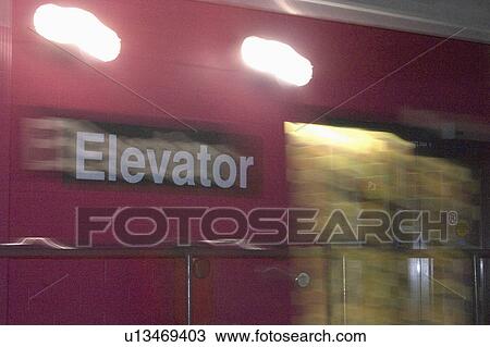 Stock Image - door, elevator, lot, parking, sign, blurry. Fotosearch