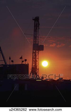 Stock Image - drilling, setting, oil, mission, behind, sun. Fotosearch