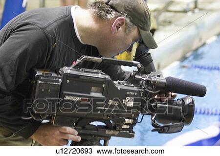 Stock Image - filming, meet, swim, college, male. Fotosearch