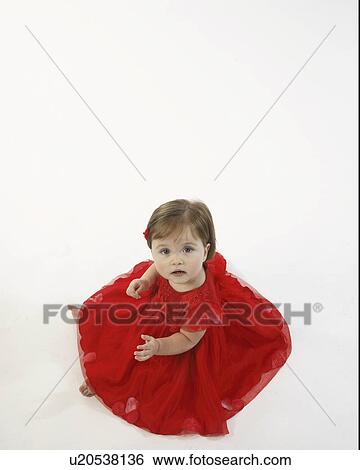 Stock Photograph - floor, girl, sitting, dress, red, little. Fotosearch