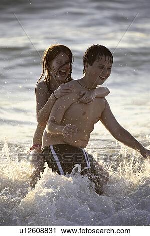 Stock Image - florida, girl, beach, surf, enjoying, boy. Fotosearch