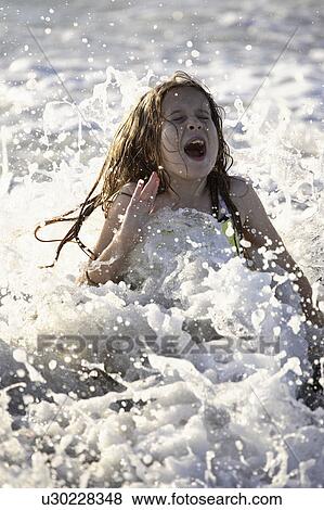Stock Photo - florida, girl, beach, surf, enjoying, young. Fotosearch