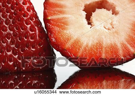 Picture - glass, cut, reflected, strawberries, whole, half. Fotosearch