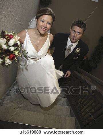 Stock Photo - groom, stairs, up, walking, bride. Fotosearch