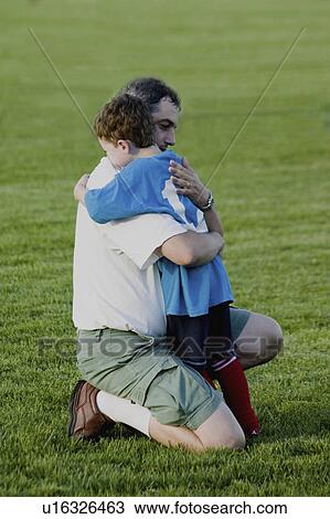 Stock Image - holding, carondelet, field, soccer, father. Fotosearch