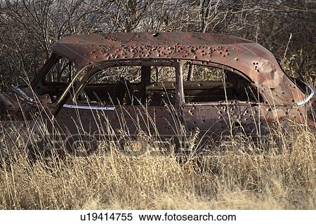 Stock Photography - holes, car, abandoned, bullet. Fotosearch