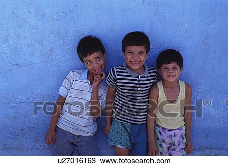 Stock Image - humor, hispanic, mocking, boys, mexican, three. Fotosearch