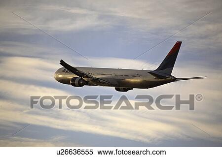 Stock Photography - light, jetliner, morning, land, circling, nearby. Fotosearch
