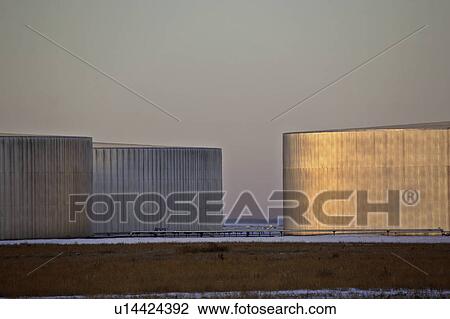 Stock Image - lihjting, storage, sun, morning, tanks, oil. Fotosearch