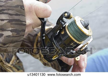Stock Image - nisswa, holding, reel, spinning, nice, fisherman. Fotosearch