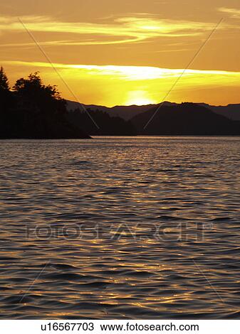 Stock Image - orange, reflected, sunset, yellow, beautiful. Fotosearch