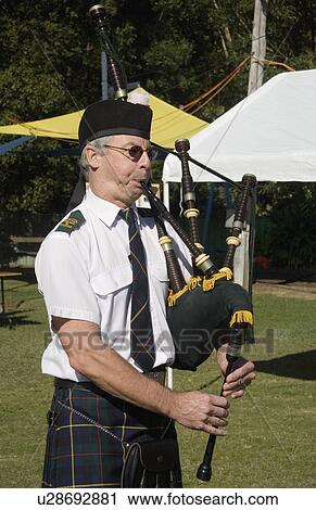 Stock Image - palying, traditional, wearing, bagpipes, male. Fotosearch