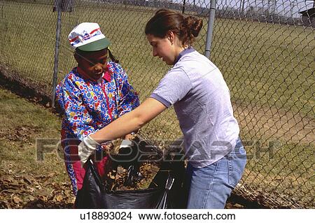 Picture - paul, kids, leaves, up, picking, volunteer. Fotosearch