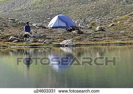 Stock Image - released, tent, sitting, male, model. Fotosearch