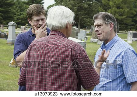 Stock Image - river, males, blue, cemetery, talking, men. Fotosearch