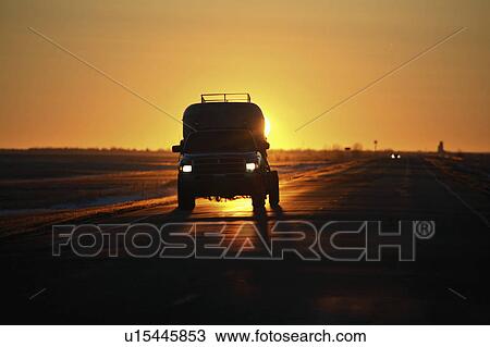 Stock Image - saskatchewan, backlit, scenic, sun, rising, vehicle. Fotosearch