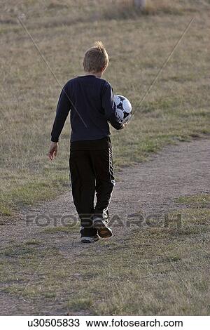 Stock Image - saskatchewan, carrying, scenic, ball, soccer, boy. Fotosearch