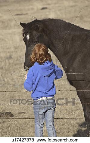 Stock Photo - saskatchewan, girl, scenic, horse, feeding, young. Fotosearch