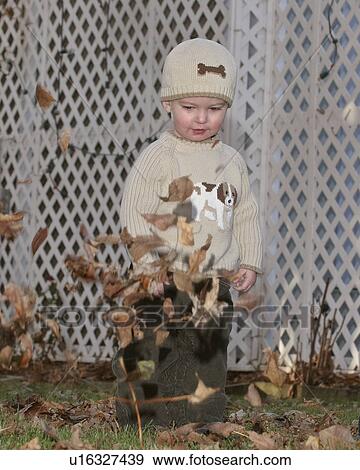Stock Photo - scenic, boy, leaves, autumn, playing, young. Fotosearch