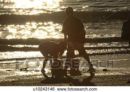 Stock Photograph - scenic, kids, sunset, beach, enjoying, children. Fotosearch