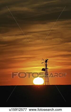 Stock Photo - scenic, setting, windmill, broken, behind, sun. Fotosearch