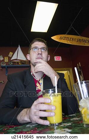 sitting, juice, orange, restaurant, male View Large Photo Image Stock Photography - sitting, juice, orange, restaurant, male. Fotosearch