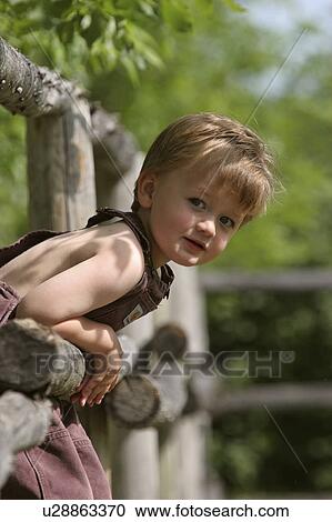 Stock Image - southern, boy, scenic, fence, playing, young. Fotosearch