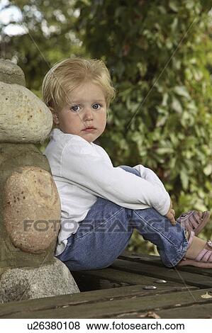 Stock Photo - stone, girl, leaning, little, posing, pretty. Fotosearch