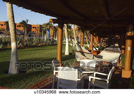 Stock Photo - sun, hotel, roof, hammocks. Fotosearch