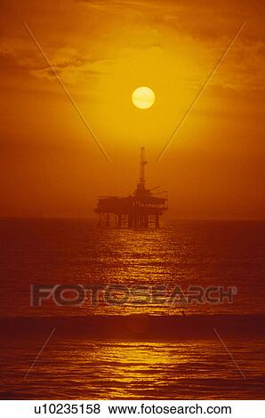 Stock Photo - sunset, oil, drilling, rig, well, offshore. Fotosearch