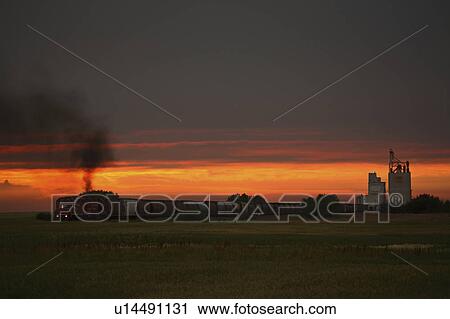 Stock Image - sunset, passing, saskatchewan, eyebrow, through, train. Fotosearch