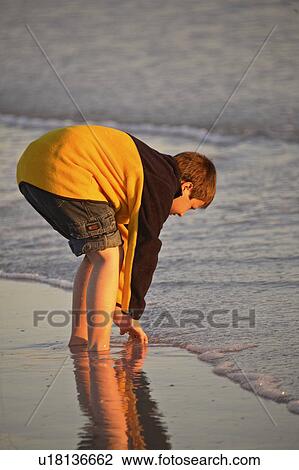Stock Image - usa, enjoying, florida, scenic, beach, boy. Fotosearch