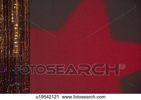 Stock Image - wall, tassle, light, star, red, gold. Fotosearch