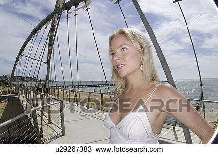 Stock Image - white, woman, beach, relaxing, female, blonde. Fotosearch