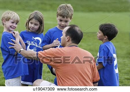 Stock Photo - 35, complimenting, age, player, soccer, coach. Fotosearch