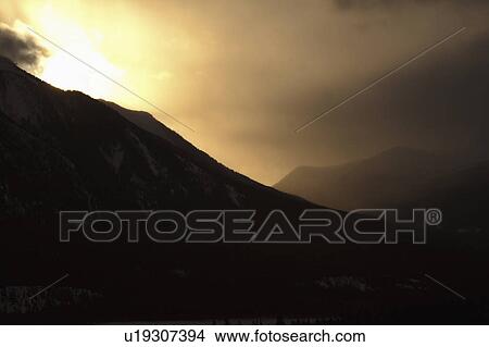 alberta, behind, rocky, mountains, clouds, sun View Large Photo Image Picture - alberta, behind, rocky, mountains, clouds, sun. Fotosearch
