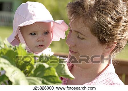 Stock Image - baby, released, holding, female, woman, model. Fotosearch