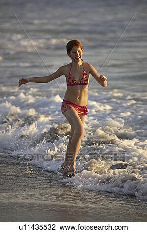 beach, girl, surf, through, running, young View Large Photo Image Stock Image - beach, girl, surf, through, running, young. Fotosearch
